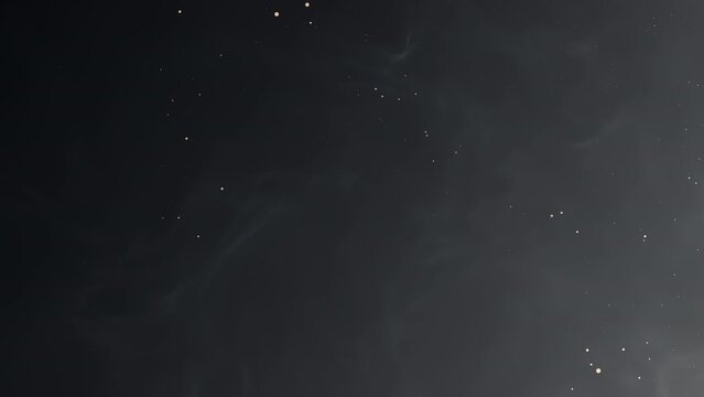 4k animated dark black abstract background with golden particles. Seamless loop with grey smoke. Smoky festive backdrop. Magical Christmas elegant blank graphite color BG. Luxury premium glowing sale