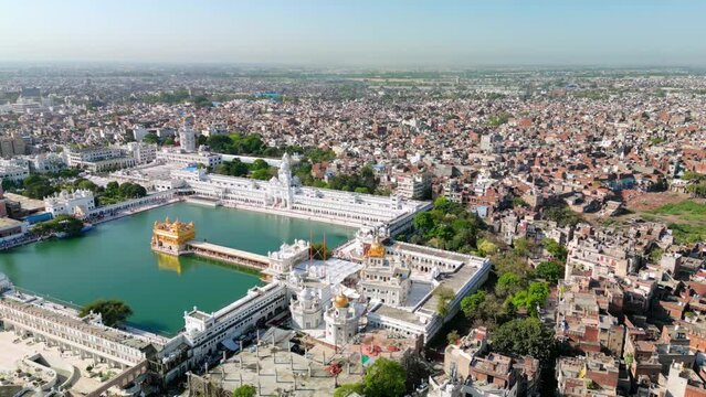 Amritsar, India: Aerial view of famous city in Punjab, iconic landmark The Golden Temple (Harimandir Sahib) - landscape panorama of South Asia from above