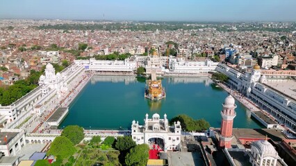 Amritsar, India: Aerial view of famous city in Punjab, iconic landmark The Golden Temple (Harimandir Sahib) - landscape panorama of South Asia from above