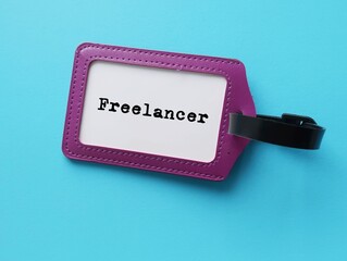 ID card holder on blue background with job title  FREELANCER - freelance worker who is...