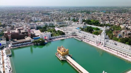 Amritsar, India: Aerial view of famous city in Punjab, iconic landmark The Golden Temple (Harimandir Sahib) - landscape panorama of South Asia from above