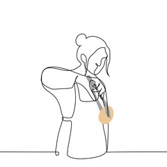 woman stands with kitchen tongs holding a bun - one line art vector. concept seller in a bakery, a woman prepared pastries