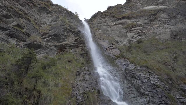 Experience the tranquil allure of a peaceful waterfall. A mesmerizing under-view of the cascading beauty
