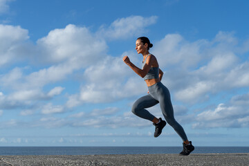 Fototapeta premium athletic brunette girl doing fitness doing exercises leading a healthy lifestyle