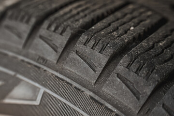 Fissures on the black rubber tire. Cracked wheel tire safety risks. Automotive service and...