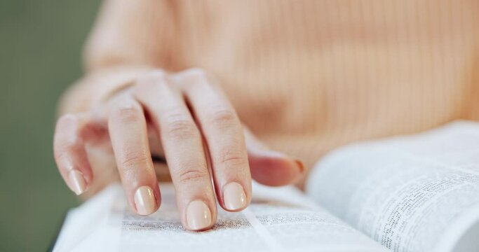 Hand, reading and woman with a bible, book and study of religion in living room, home or learning about spiritual knowledge. Christian, education and studying holy scripture of God, Jesus or faith