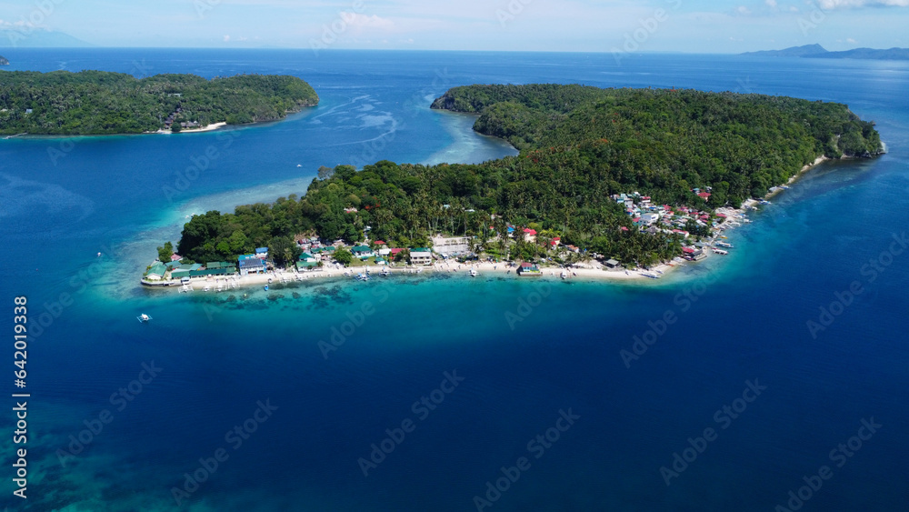 Wall mural aerial view of the blue sea, green island, sandy beach, strait, lagoon. a small settlement on the co