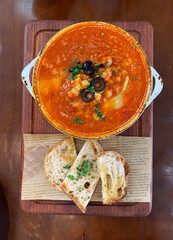 homemade tomato paste soup with egg olive macadamia bean and bread toast in bowl on wood table western fusion halal food restaurant banquet menu for cafe