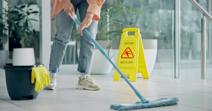Cleaning, person and mopping floor of office for cleaner service, professional janitor and maintenance. Manual labor, wet sign and worker with tools for hygiene, disinfection and washing in workplace
