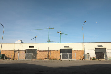 Outside view of a small, empty warehouse in an industrial area. Horizontal.