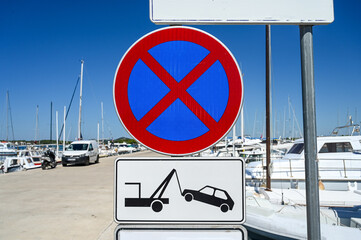 No parking sign. Tow away caution. Parking forbidden. Symbol of towing car on the street. Tow away...