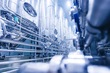 Pipes stainless steel brewing equipment, large reservoirs or tanks in modern beer factory. Brewery...