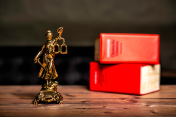 statue of Lady Justice, goddess Justitia, on the desk in a lawyer's office