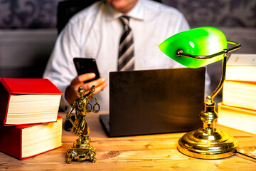 office of a lawyer with statue of Lady Justice, goddess Justitia, on the desk