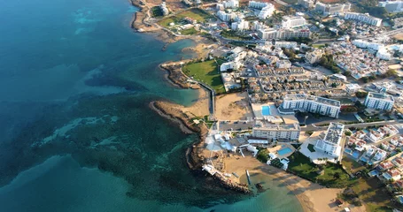 Foto op Canvas Drone shooting panorama of the coastline of the city with luxury hotels, villas, bays, ports with stylish yachts, sandy and rocky beaches and calm sea with clear blue water in Larnaca Cyprus. © Anton