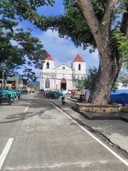 Fototapeta na wymiar Poblacion, Sibonga, Cebu - Our Lady of the Pillar Parish Church - Seaside - Sunrise - Old Trees - Streets - Pedestrian - white Brick