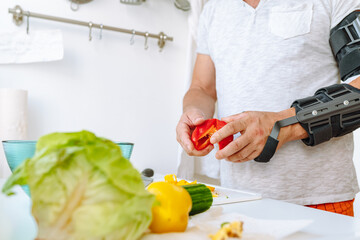 Man with injured hand making salad