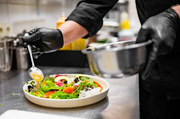 chef hands cooking Fresh sashimi salad with salmon fish, tuna and vegetables on kitchen