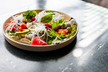 Fresh sashimi salad with salmon fish, tuna and vegetables on table