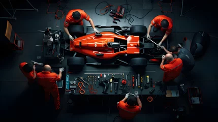 Poster Im Rahmen Top view of Formula 1 f1 race car at pit stop for maintenance, team at work © Trendy Graphics