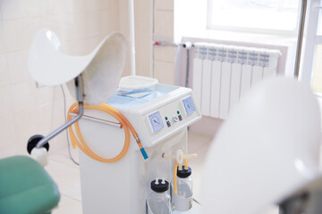 Examination room with medical aspirator for artificial abortion in clinic. Gynecological checkup