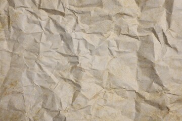 Texture of crumpled parchment paper as background, top view