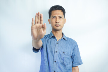 Fototapeta premium Attractive young asian man on isolated white background scared and terrified with frightened expression stop gesturing with hands, screaming in shock. Panic concept.