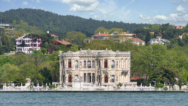 View from the Bosphorus strait of Kucuksu Pavilion, aka Kucuksu Kasri, a beautiful palace in the Asian side of Istanbul, Turkey, with green mountains in the background
