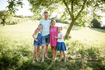Fototapeta premium young, happy family outddor in the nature, sisters, father and mother