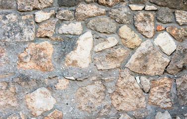 Old ancient bricks on the wall of the house as an abstract background. Texture