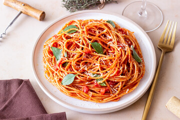 Spaghetti pasta with tomato sauce, basil and Parmesan cheese. Italian cuisine. Vegetarian food.