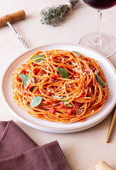 Spaghetti pasta with tomato sauce, basil and Parmesan cheese. Italian cuisine. Vegetarian food.