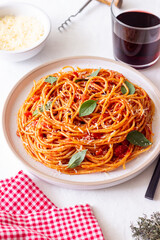 Spaghetti pasta with tomato sauce, basil and Parmesan cheese. Italian cuisine. Vegetarian food.