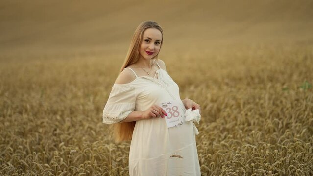 Pregnant woman in a wheat field