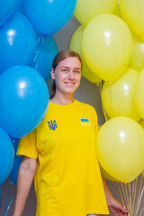 Ukrainian woman among blue and yellow balloons