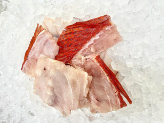 fresh raw cold seafood seven star whole fish ikan head, fillet, meat, cut, tail on white ice...