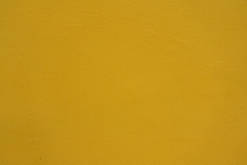Fototapeta premium Texture of saffron yellow painted wall