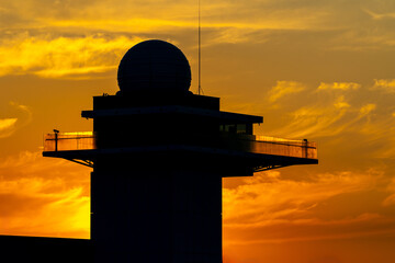 The dome of the astronomical observatory against the orange, sunset sky. Daily sky observations....