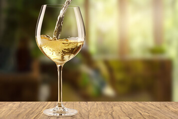White wine being poured in the wineglass 32K Natural Light
