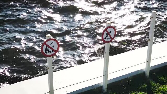 prohibitory signs on the pier do not fishing and diving to swimming. Lapping wave water . The concept of a safety rule