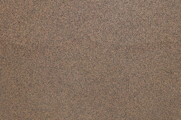 Fototapeta na wymiar Texture of wall with coarse brown and black pebbledash finish