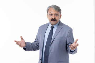 Young handsome businessman wearing suit standing over isolated white background clueless and confused expression with arms and hands raised.