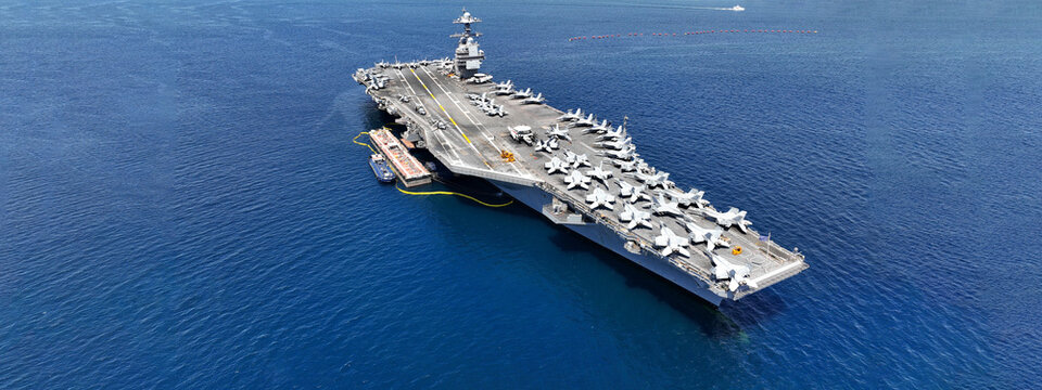 Aerial drone ultra wide panoramic photo with copy space of latest technology nuclear powered aircraft carrier USS Gerald R. Ford anchored in deep blue open ocean sea