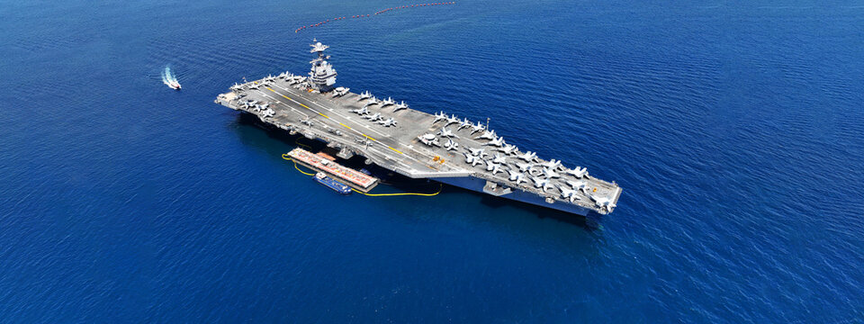 Aerial drone ultra wide panoramic photo with copy space of latest technology nuclear powered aircraft carrier USS Gerald R. Ford anchored in deep blue open ocean sea