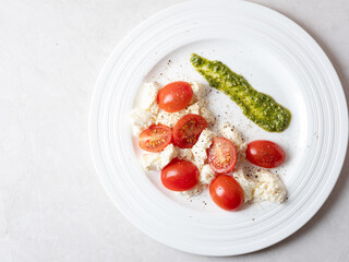 Cherry tomato salad with cheese on a plate