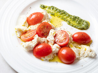 Cherry tomato salad with cheese on a plate