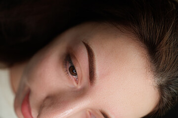 Completed work on permanent make-up of eyebrows. Eyebrow permanent makeup cosmetic procedure.