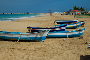 Fototapeta na wymiar Boats in Vila do Maio, Island in Cape Verde boasts exquisite beaches. With their soft sands, azure waters, and tranquil ambiance, they offer a serene tropical paradise.