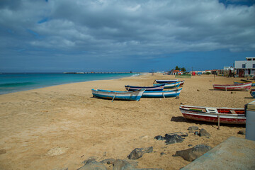 Obraz premium Boats in Vila do Maio, Island in Cape Verde boasts exquisite beaches. With their soft sands, azure waters, and tranquil ambiance, they offer a serene tropical paradise.