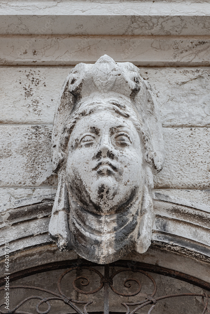 Wall mural Venice, Italy - September 28, 2019: Portrait with a ancient wall decoration sculpture of a beautiful woman, Greek or Italian in historical downtown of Venice